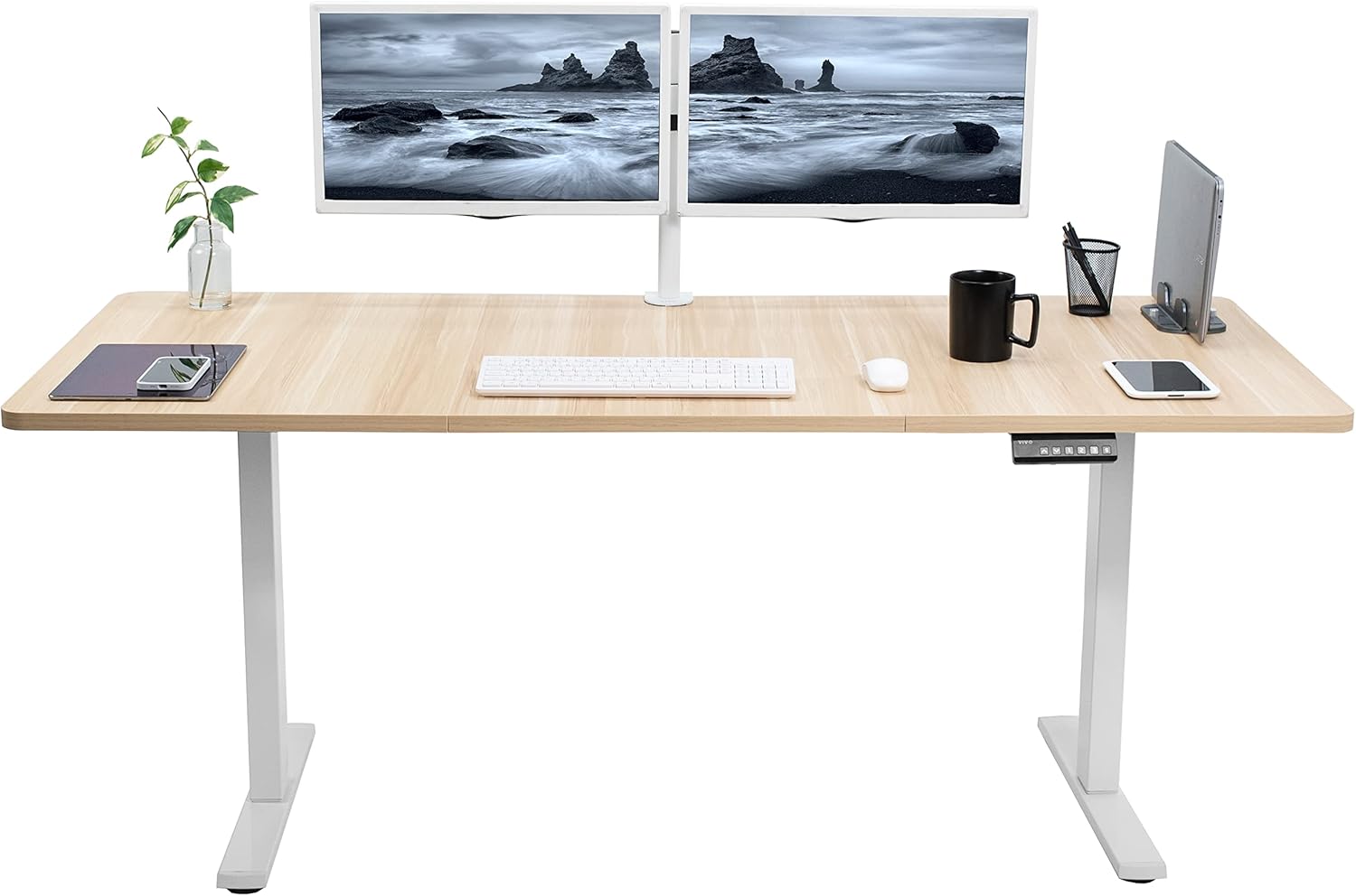 A vibrant home office space with a vertical monitor, laptop, and creative lighting.
